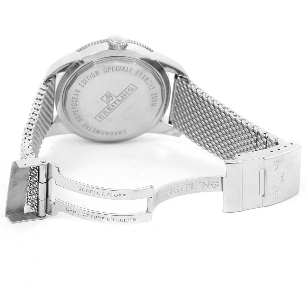 The image shows the back of a Breitling Superocean A17320 Men's Stainless Steel Brown Dial A17320 Men's Stainless Steel Brown Dial watch with its case back, crown, and open mesh bracelet with the clasp visible.