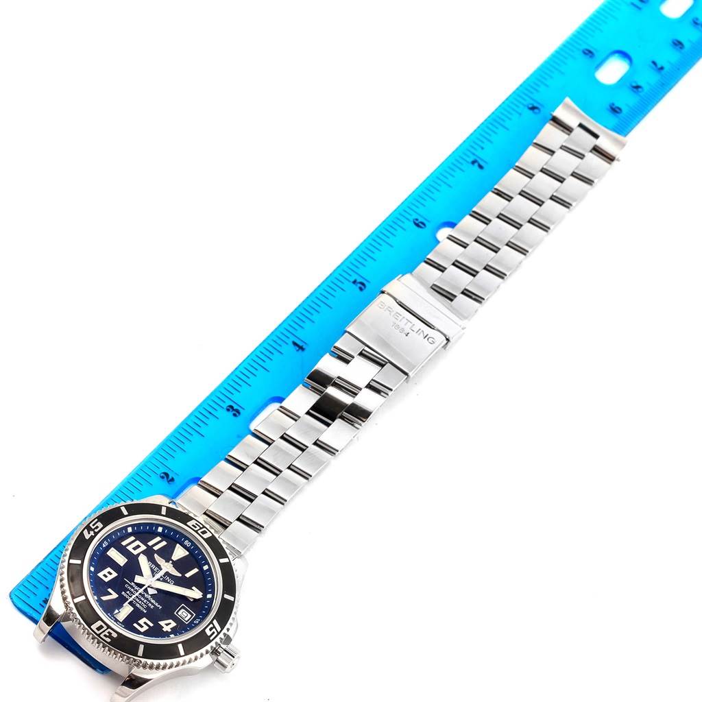 This image shows a Breitling Superocean A17364 Men's Stainless Steel Black Dial A17364 Men's Stainless Steel Black Dial watch from above, featuring the face, bezel, lugs, and stainless steel bracelet with clasp, next to a ruler.