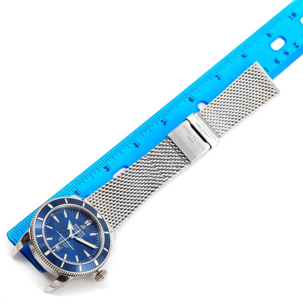 The image shows a Breitling Superocean A17320 Men's Stainless Steel Blue Dial A17320 Men's Stainless Steel Blue Dial watch from a top-down angle, displaying the face, bezel, and mesh bracelet.