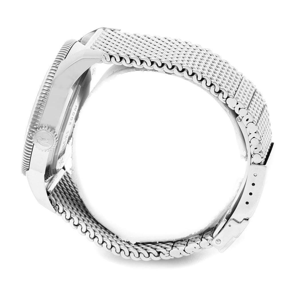 The image shows a side view of a Breitling Superocean A17320 Men's Stainless Steel Blue Dial A17320 Men's Stainless Steel Blue Dial watch, highlighting the case, crown, and metal mesh bracelet.