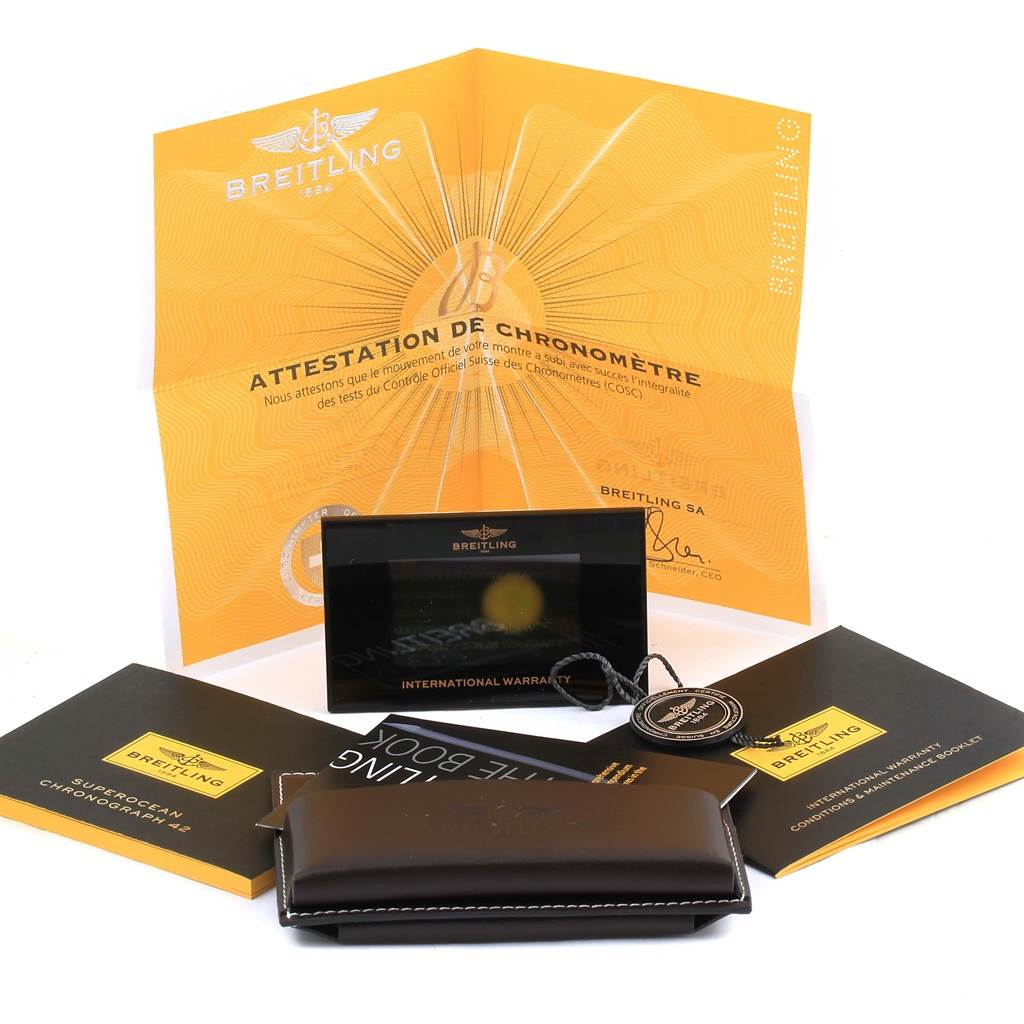 The image shows documents and accessories for the Breitling Superocean A13311 Men's Stainless Steel Blue Dial A13311 Men's Stainless Steel Blue Dial, including warranty cards, manuals, a certification, and a watch case.