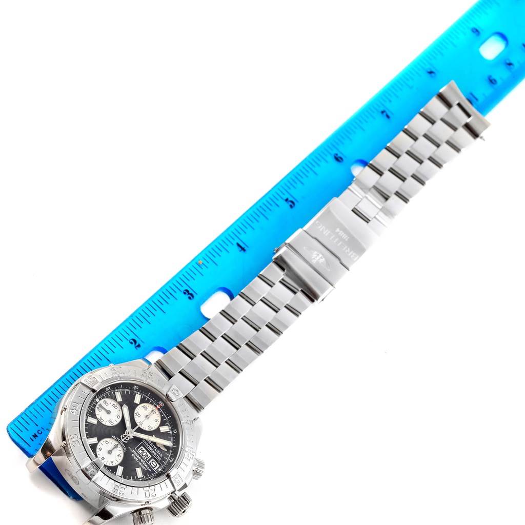 The image shows the Breitling Superocean A13340 Men's Stainless Steel Black Dial A13340 Men's Stainless Steel Black Dial watch laid flat with its stainless steel bracelet and a blue ruler for measurement.