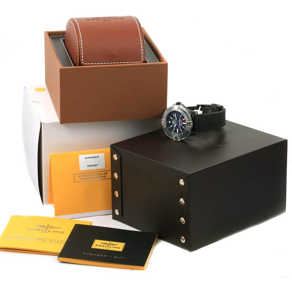 The photograph shows a Breitling Avenger M32390 Men's Stainless Steel Black Dial M32390 Men's Stainless Steel Black Dial watch with its packaging, manual, warranty card, and display box from a front perspective.