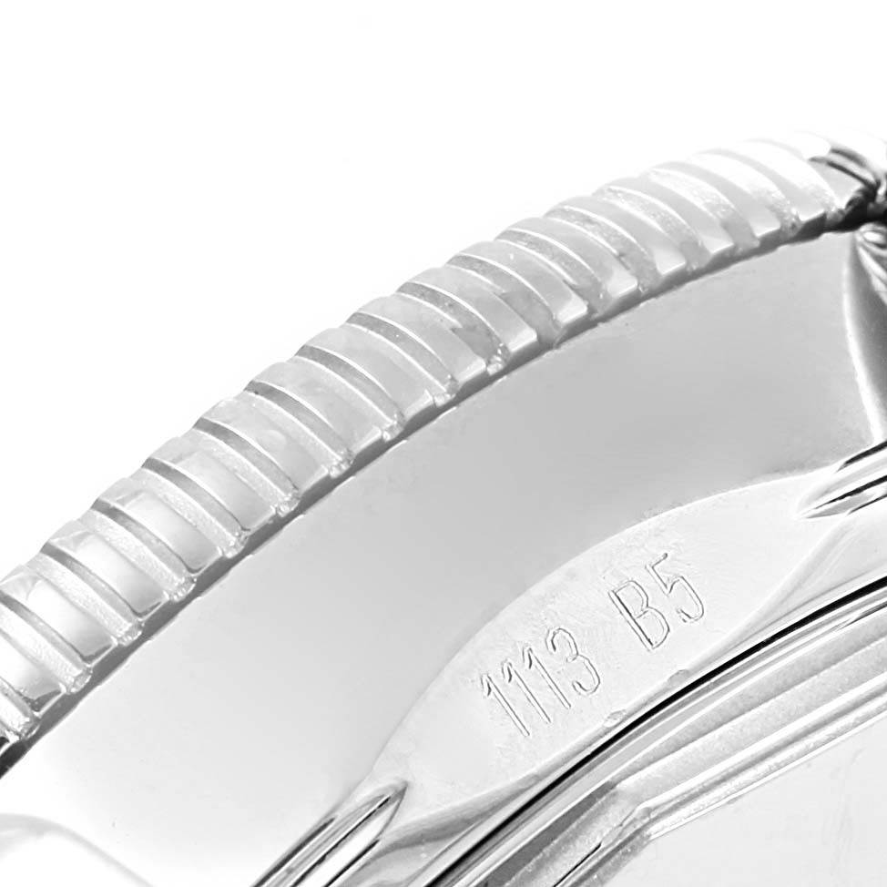 The image shows a close-up of the side edge of the Breitling Superocean A17321 Men's Stainless Steel Black Dial A17321 Men's Stainless Steel Black Dial watch bezel with its textured design and engraved markings.
