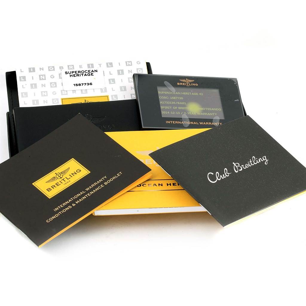 The image shows documentation and accessory items for the Breitling Superocean A17321 Men's Stainless Steel Black Dial A17321 Men's Stainless Steel Black Dial Heritage watch, including warranty cards and booklets.