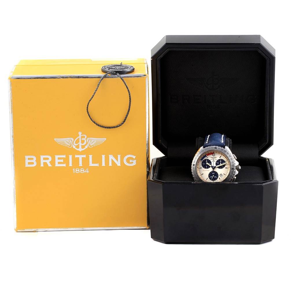 The image shows a Breitling Superocean A53605 Men's Stainless Steel Silver Dial A53605 Men's Stainless Steel Silver Dial watch in an open black box next to a yellow Breitling branded package.