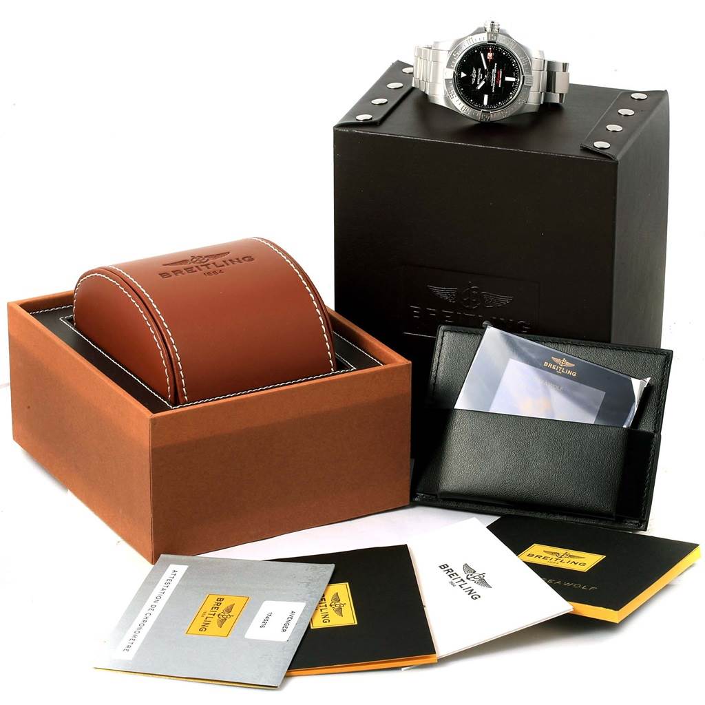 The image shows a Breitling Avenger A17331 Men's Stainless Steel Black Dial A17331 Men's Stainless Steel Black Dial watch atop a black box, with additional boxes, documentation, and a leather case.