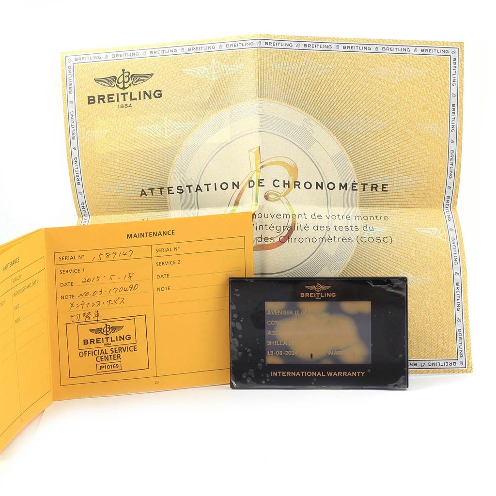 The image shows Breitling Avenger A32390 Men's Stainless Steel Black Dial A32390 Men's Stainless Steel Black Dial's warranty card, maintenance book, and chronometer certification paper, all flat and arranged.