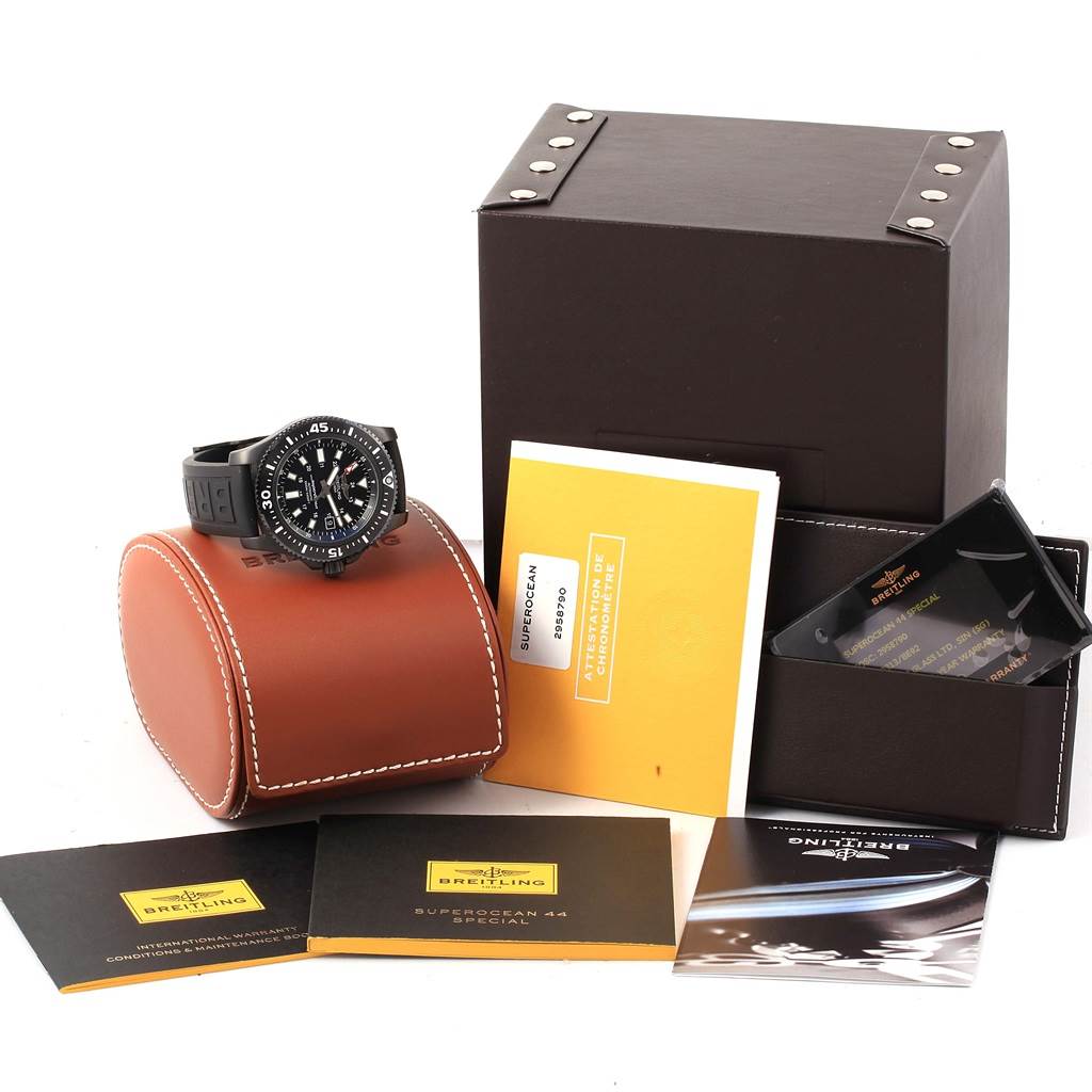 The image shows a Breitling Superocean M17393 Men's Stainless Steel Black Dial M17393 Men's Stainless Steel Black Dial watch at an angle along with its box, documents, and warranty card.