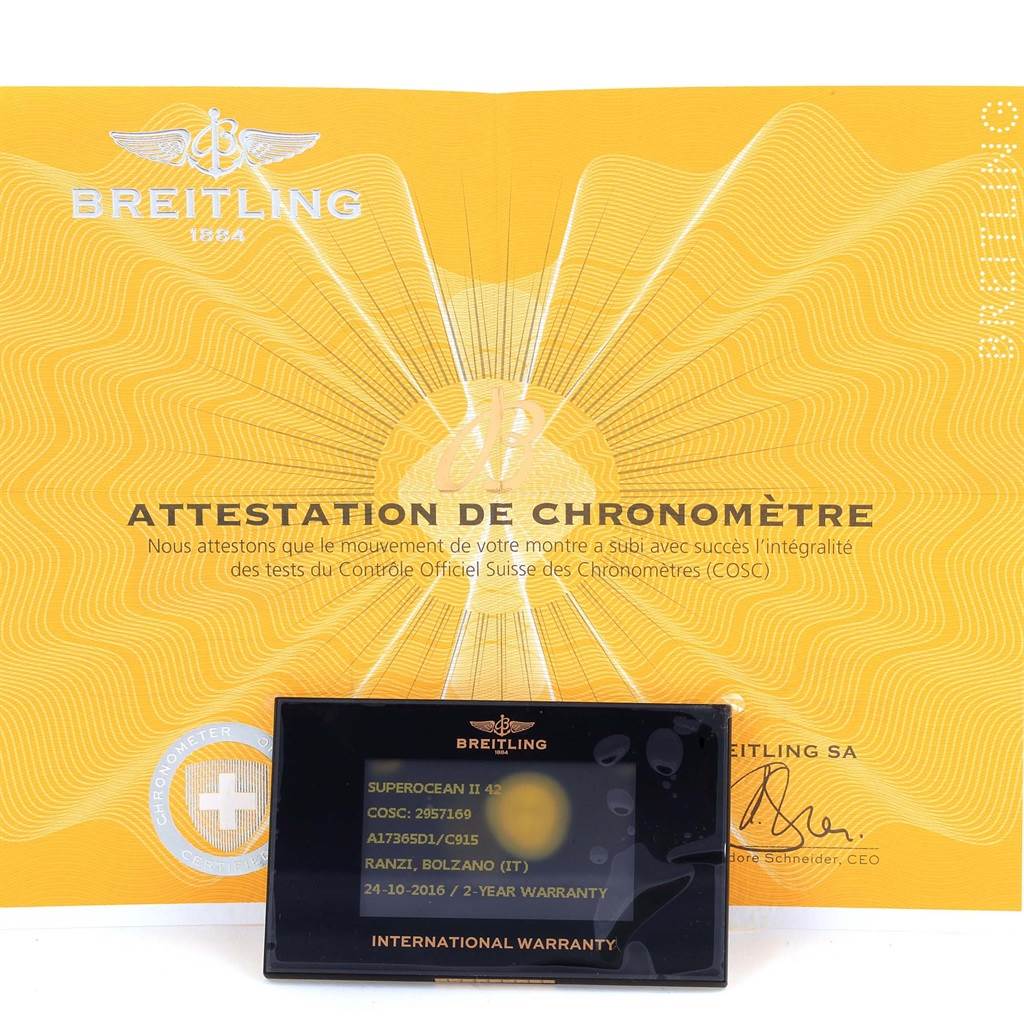 The image shows documentation and warranty card for a Breitling Superocean A17365 Men's Stainless Steel Blue Dial A17365 Men's Stainless Steel Blue Dial model, including an attestation de chronomètre certificate.