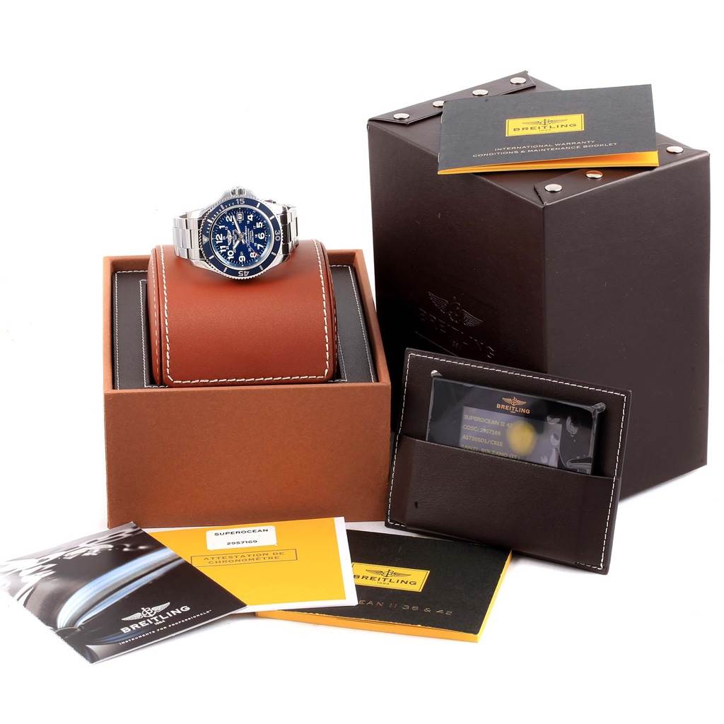 The Breitling Superocean A17365 Men's Stainless Steel Blue Dial A17365 Men's Stainless Steel Blue Dial watch is displayed at a front angle with its packaging, manuals, and warranty card.