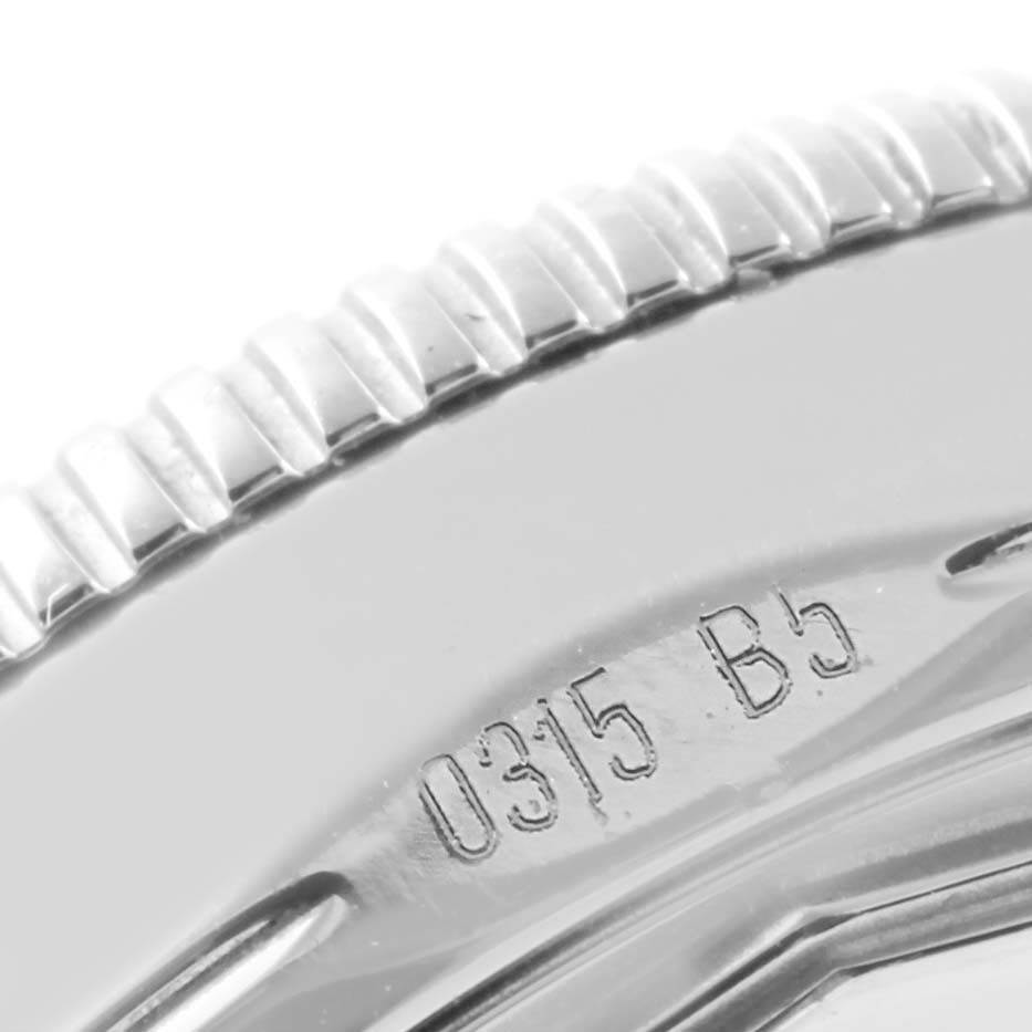 The image shows a close-up of the bezel and edge of a Breitling Superocean A17321 Men's Stainless Steel White Dial A17321 Men's Stainless Steel White Dial model watch, highlighting the engraved serial number.