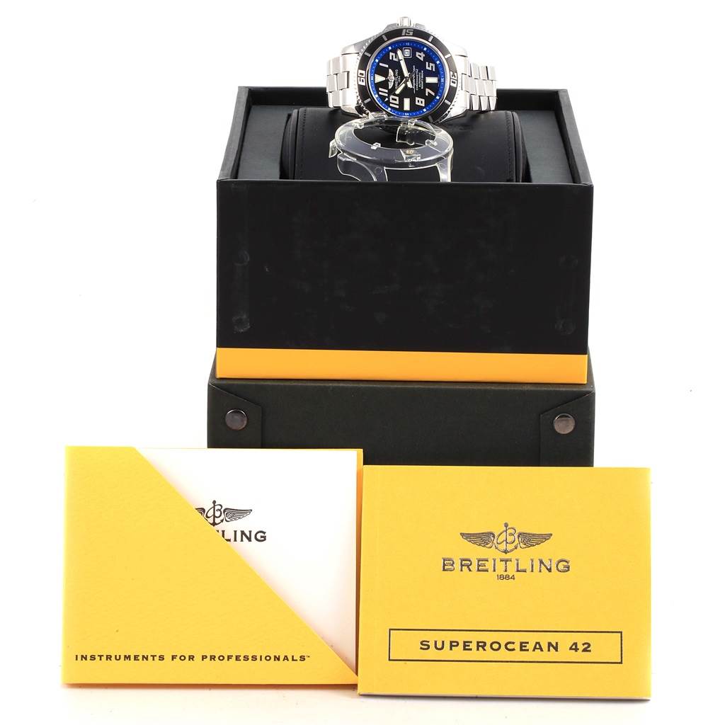 The image shows a Breitling Superocean A17364 Men's Stainless Steel Black Dial A17364 Men's Stainless Steel Black Dial watch from the front, atop its box, with accompanying manuals displayed below.