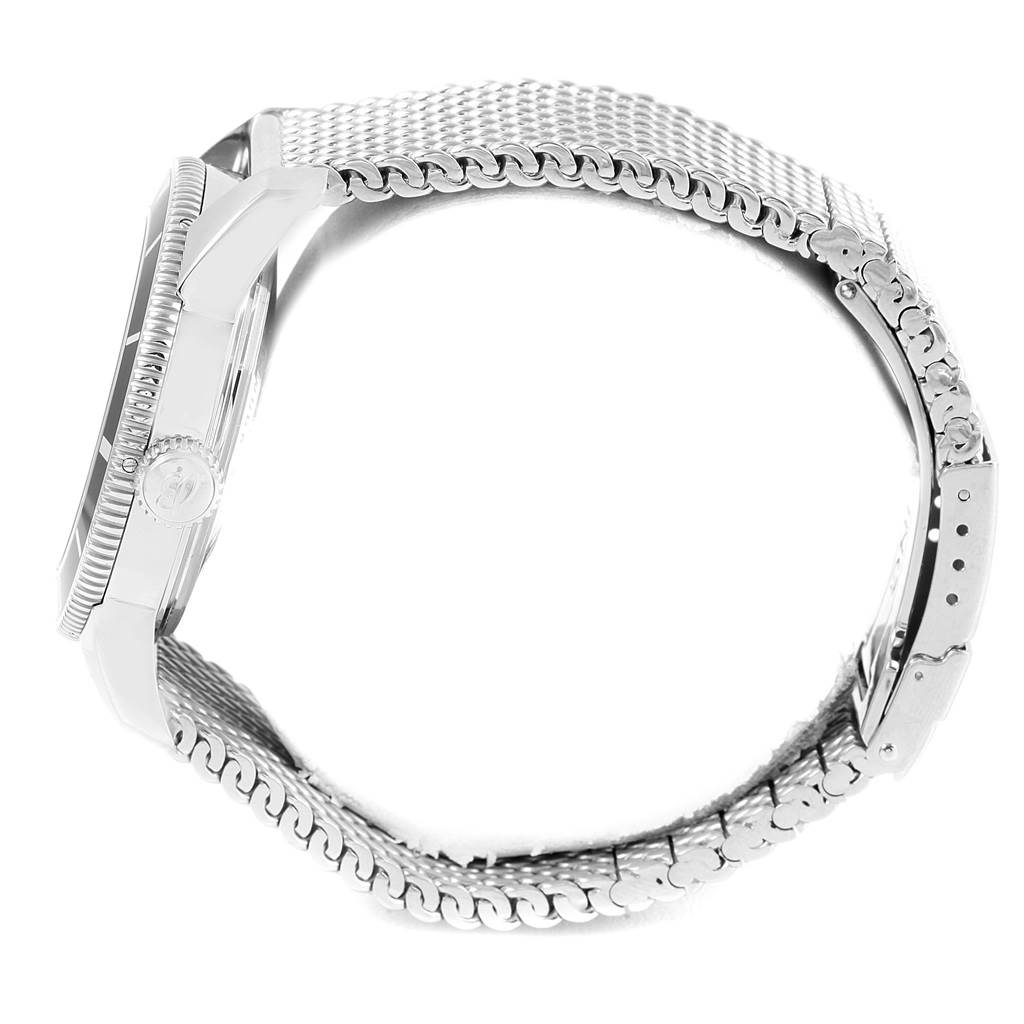 The image shows a side view of a Breitling Superocean A17321 Men's Stainless Steel Black Dial A17321 Men's Stainless Steel Black Dial watch, highlighting its bezel, case, crown, and metal mesh strap.