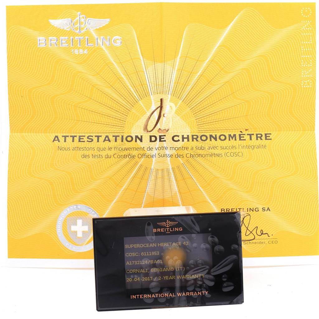 The image shows a Breitling Superocean A17321 Men's Stainless Steel Black Dial A17321 Men's Stainless Steel Black Dial watch certificate and international warranty card, photographed from a top-down angle.