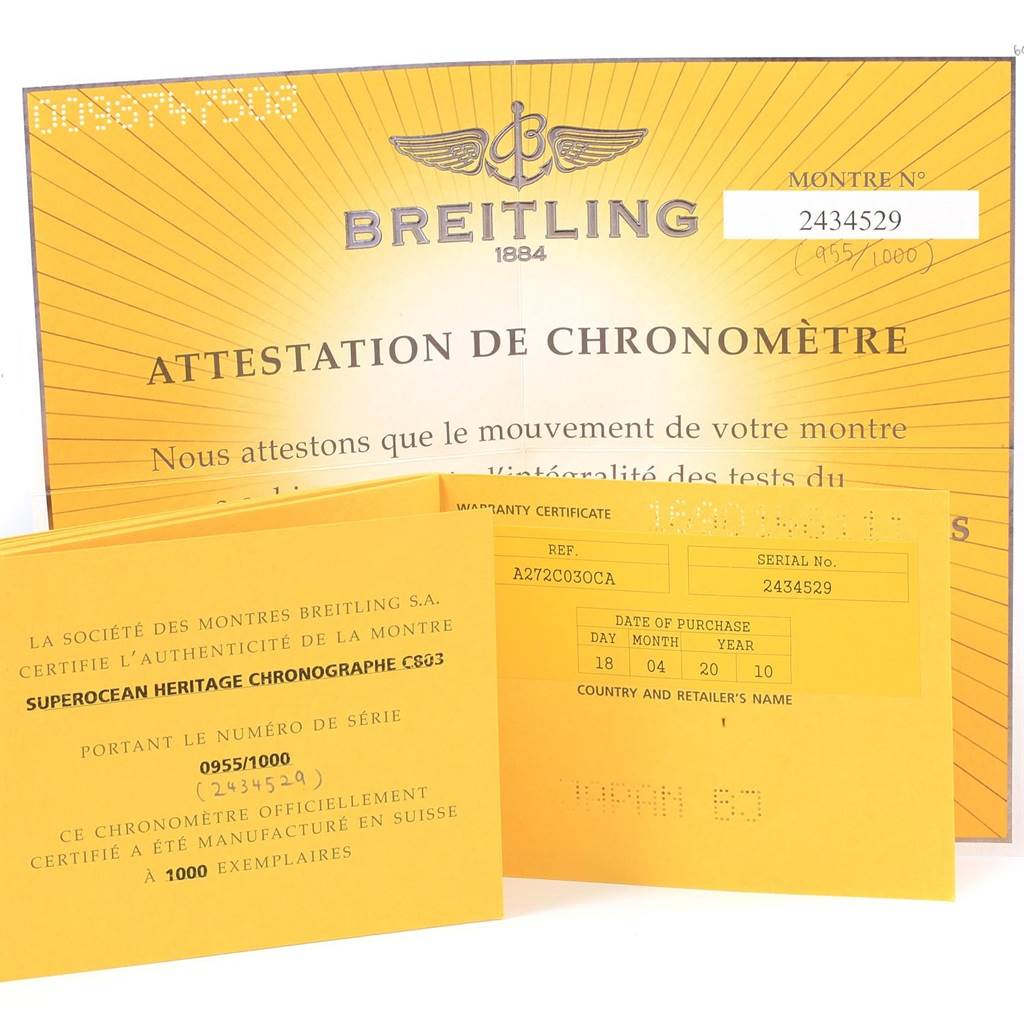 The image shows warranty and authenticity certificates for a Breitling Superocean A23320 Men's Stainless Steel Blue Dial A23320 Men's Stainless Steel Blue Dial model, displayed at an angle showing their front sides.