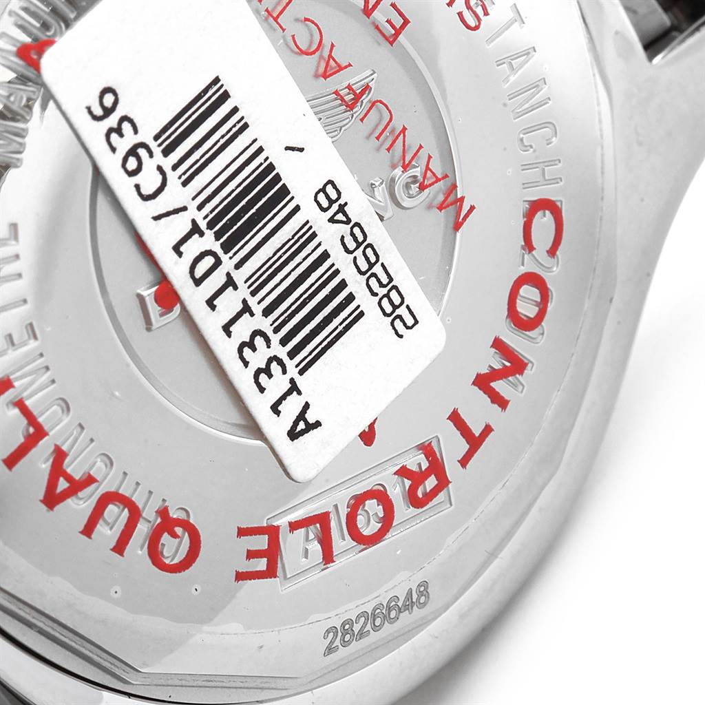 The image shows the back of a Breitling Superocean A13311 Men's Stainless Steel Blue Dial A13311 Men's Stainless Steel Blue Dial watch with a barcode sticker partially covering the engraving.