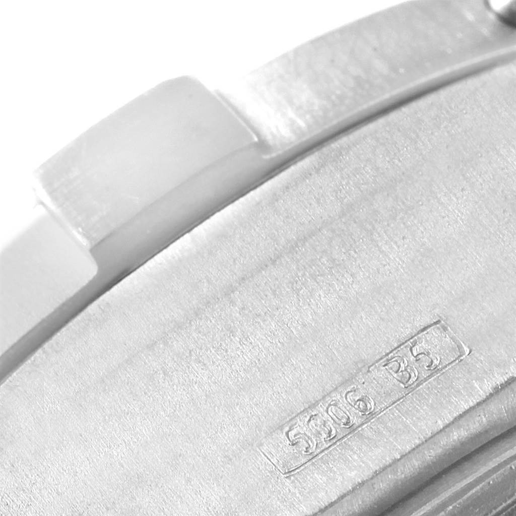 The image shows a close-up of the side of a Breitling Avenger E13360 Men's Titanium  E13360 Men's Titanium  watch, focusing on the serial number and part of the bezel.