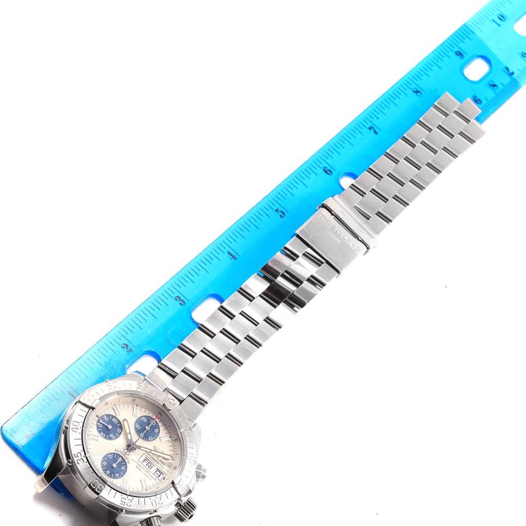 The image shows a Breitling Superocean A13340 Men's Stainless Steel Beige Dial A13340 Men's Stainless Steel Beige Dial watch laid flat with a blue ruler next to it.