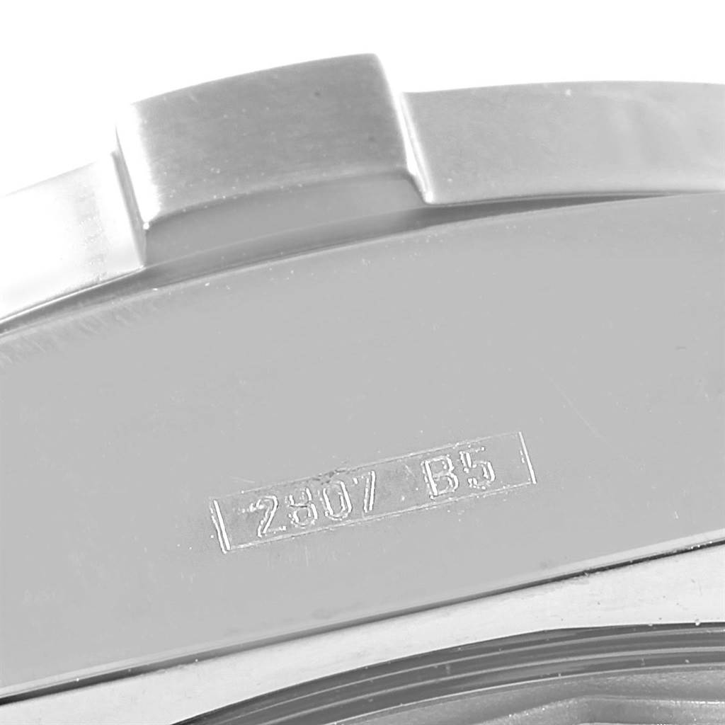 The image shows a close-up of the case back and a part of the bezel of a Breitling Avenger A13380 Men's Stainless Steel Black Dial A13380 Men's Stainless Steel Black Dial watch with stamped serial number.