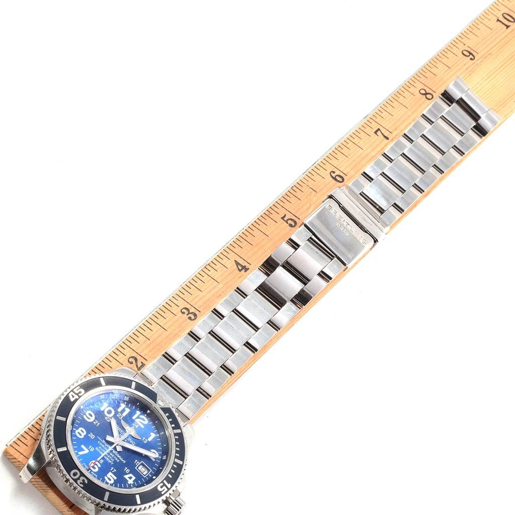 The image shows a Breitling Superocean A17365 Men's Stainless Steel Blue Dial A17365 Men's Stainless Steel Blue Dial watch laid flat with a measuring ruler next to it, displaying its entire band and watch face.