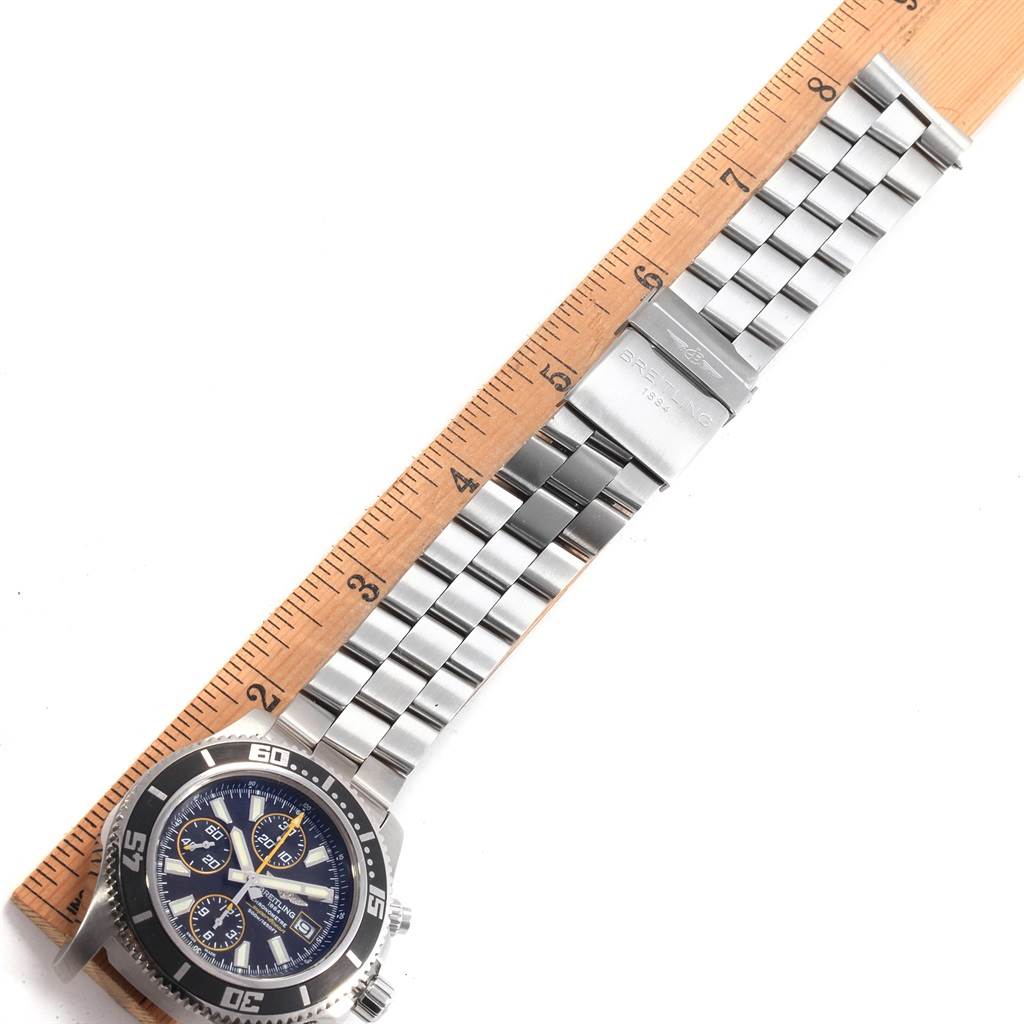 The image shows a Breitling Superocean A13341 Men's Stainless Steel Black Dial A13341 Men's Stainless Steel Black Dial watch laid flat with its stainless steel bracelet and clasp extended alongside a ruler.