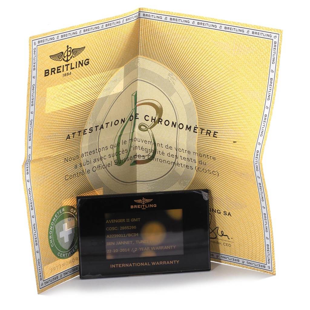 The image shows a Breitling Avenger A32390 Men's Stainless Steel Black Dial A32390 Men's Stainless Steel Black Dial model certificate and an international warranty card in the foreground.