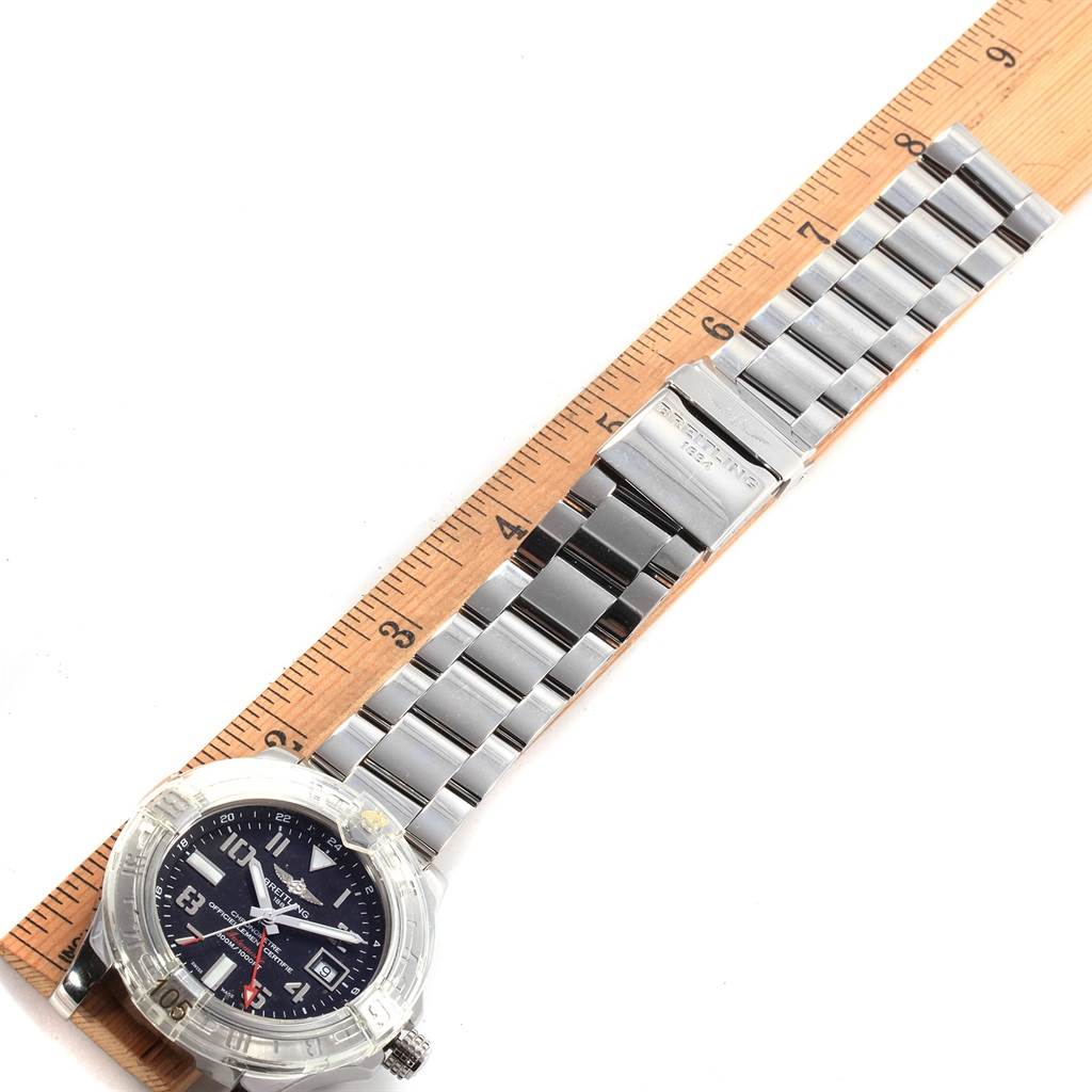 The Breitling Avenger A32390 Men's Stainless Steel Black Dial A32390 Men's Stainless Steel Black Dial watch is shown from a top-down angle, highlighting its face, bezel, and metallic strap alongside a ruler.