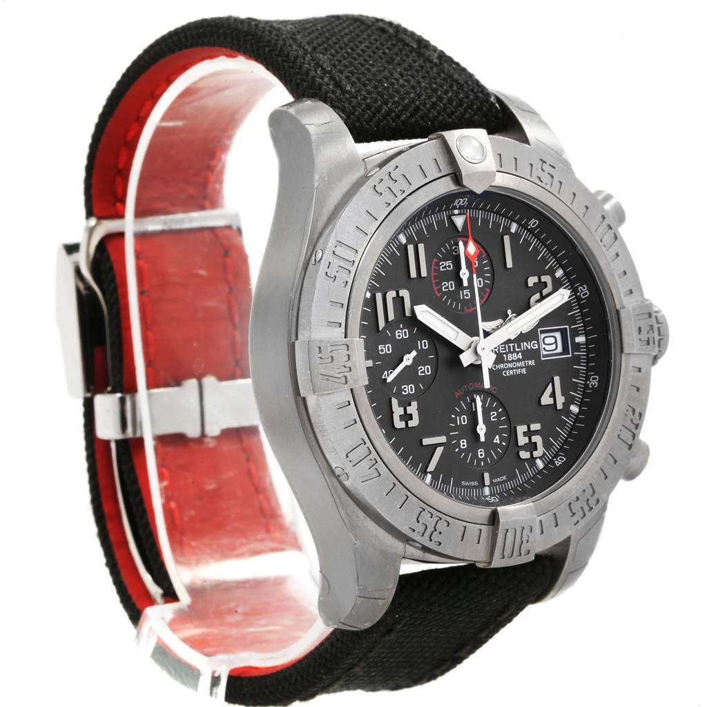 The image shows a Breitling Avenger E13383 Men's Titanium Grey Dial E13383 Men's Titanium Grey Dial watch at an angled side view, highlighting its black dial, bezel, and black strap with red lining.