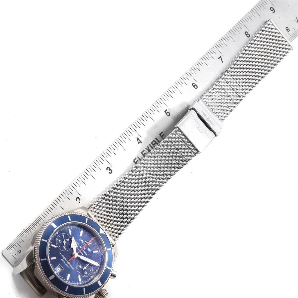 The image shows a top-view angle of a Breitling Superocean A23370 Men
s Stainless Steel Blue Dial A23370 Men
s Stainless Steel Blue Dial watch with a mesh bracelet and a ruler for scale.