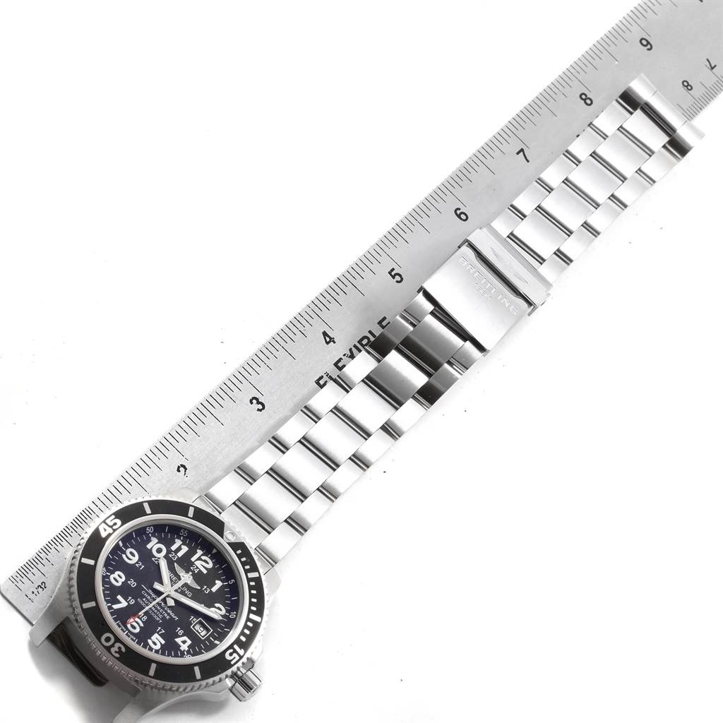The image shows a top-down view of the Breitling Superocean A17392D8/C910 Men's Stainless Steel Black Dial A17392D8/C910 Men's Stainless Steel Black Dial watch and its metal bracelet, with a ruler measuring its length.