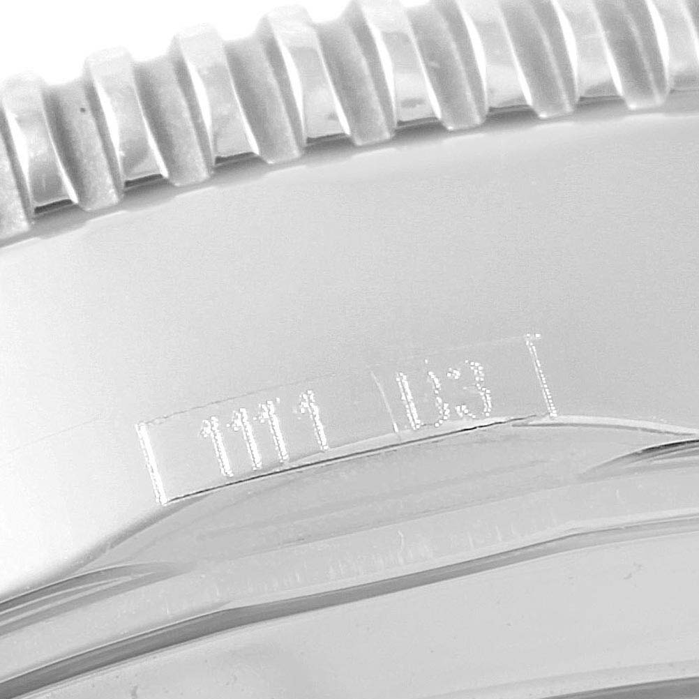 The image shows a close-up of the bezel and part of the case of a Breitling Superocean A13320 Men's Stainless Steel Blue Dial A13320 Men's Stainless Steel Blue Dial watch, including its serial number.