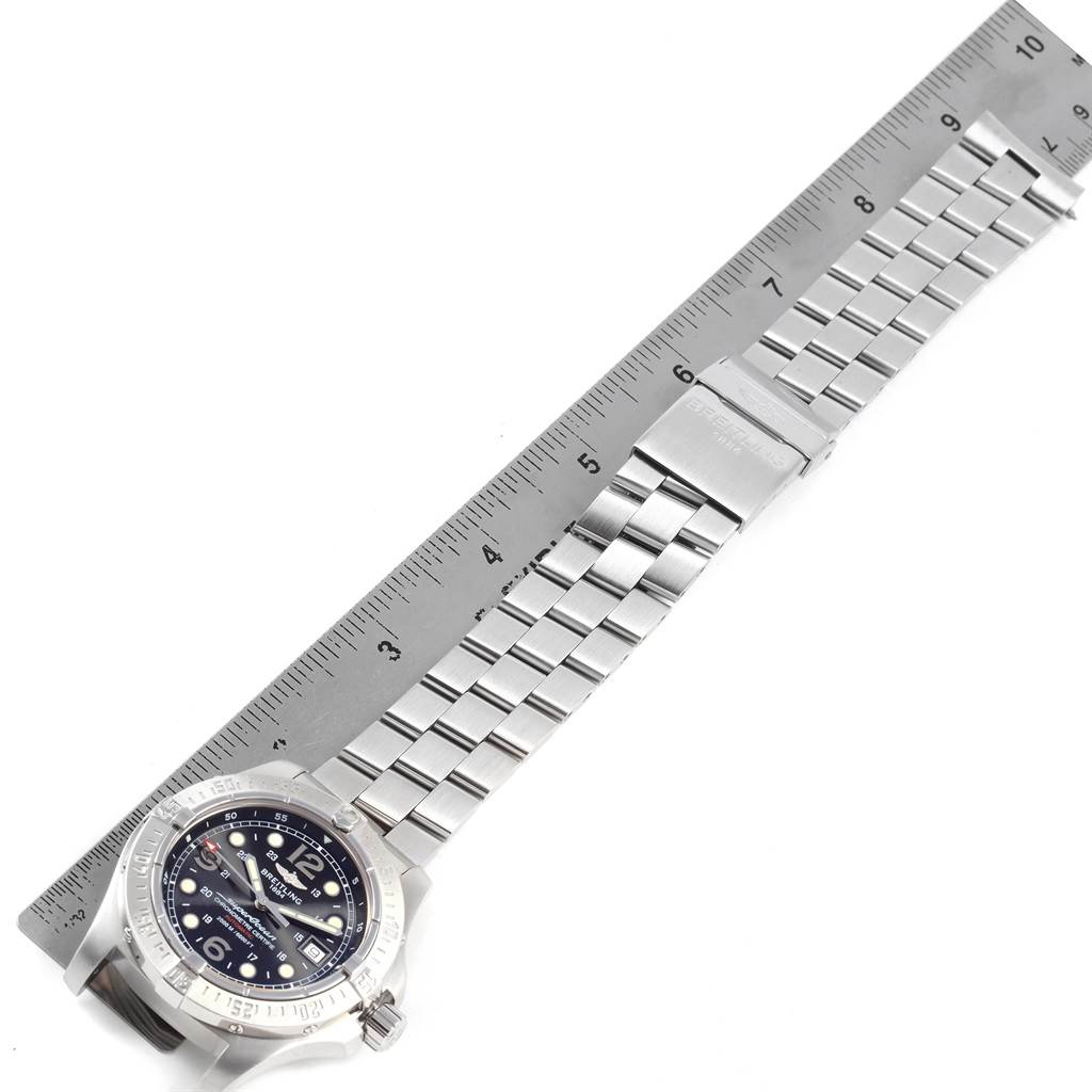 The image shows a Breitling Superocean A17390 Men's Stainless Steel Black Dial A17390 Men's Stainless Steel Black Dial watch laid flat with its stainless steel band aligned alongside a ruler.