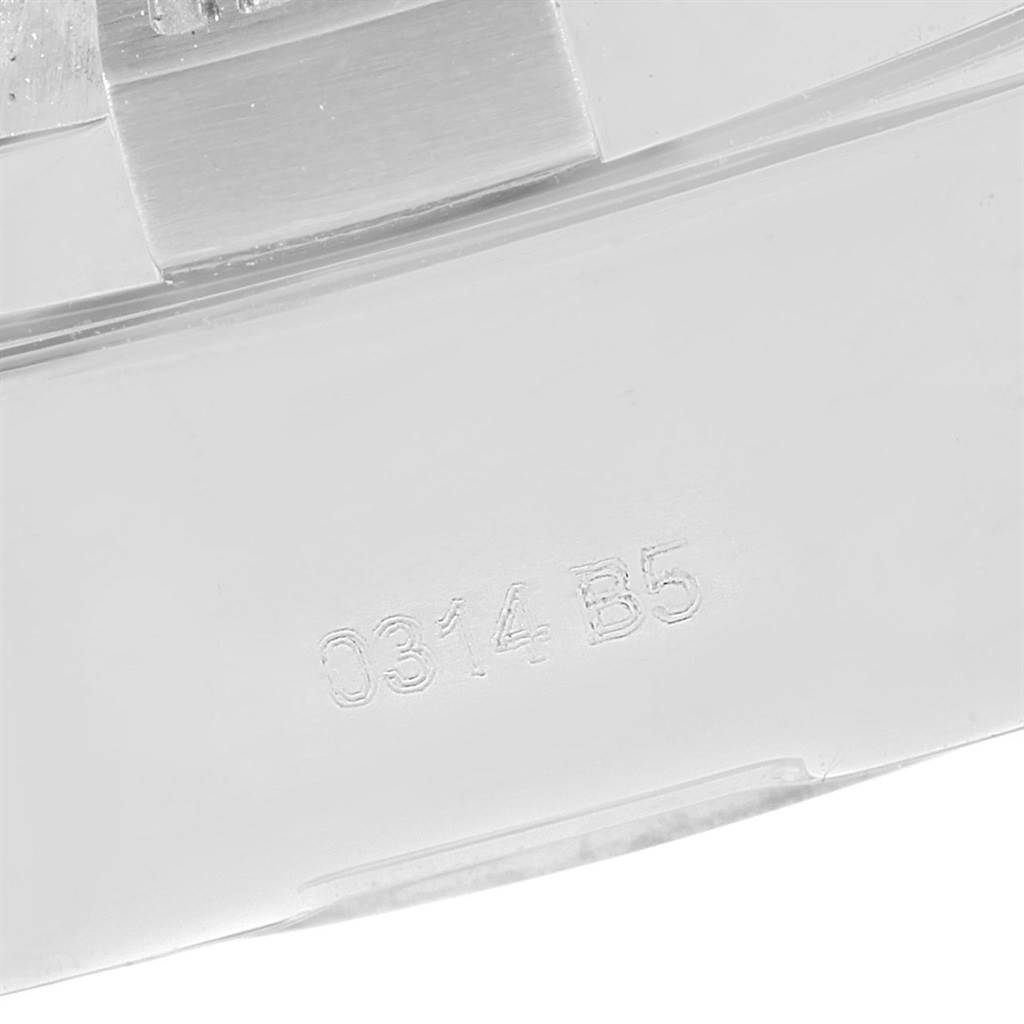 The image shows a close-up view of a metallic part, possibly the clasp or backplate, of an Avenger model by Breitling with an engraving "0314.B5".