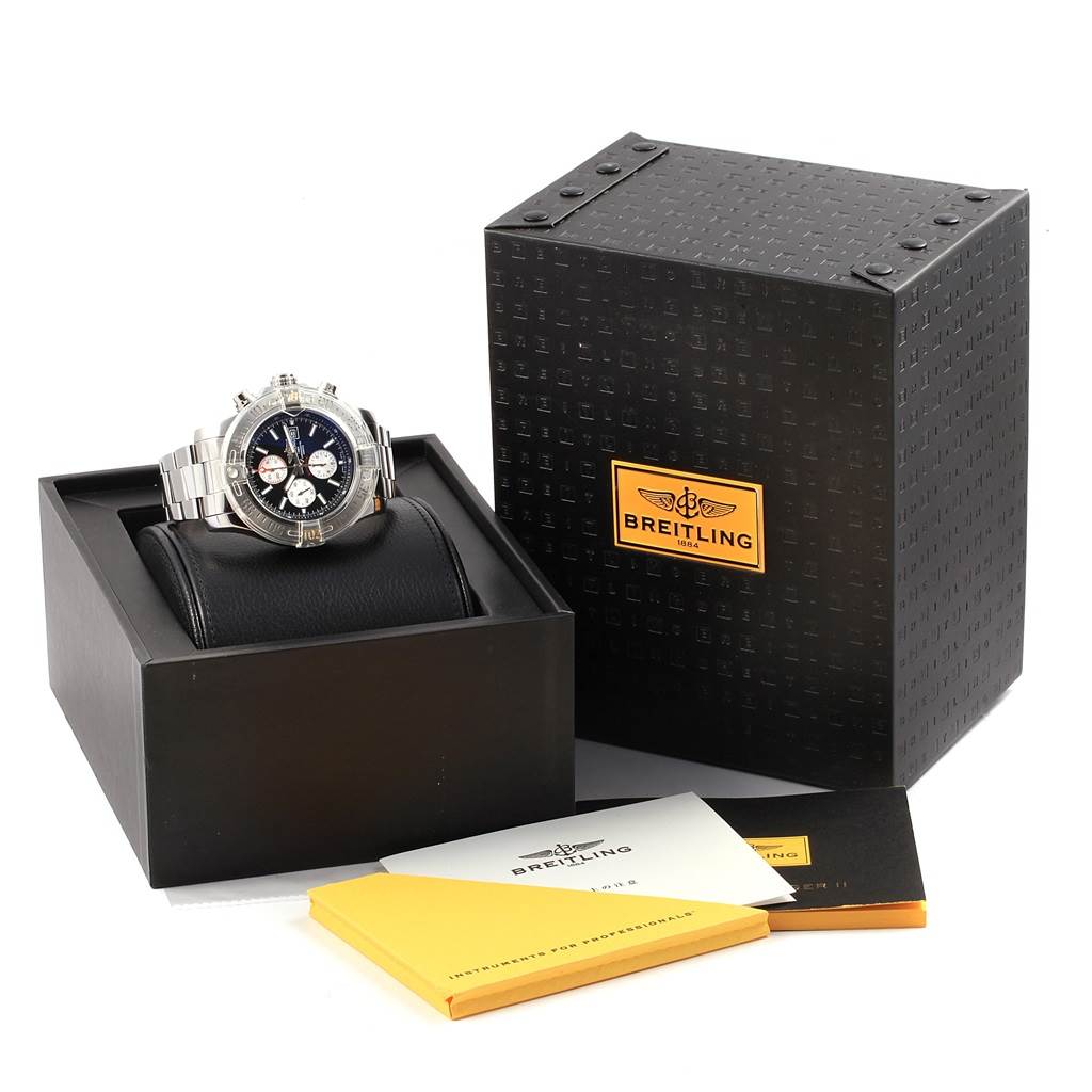 The Breitling Avenger A13371 Men's Stainless Steel Black Dial A13371 Men's Stainless Steel Black Dial watch is shown from the front, placed on a cushion, alongside its box and accompanying manuals.