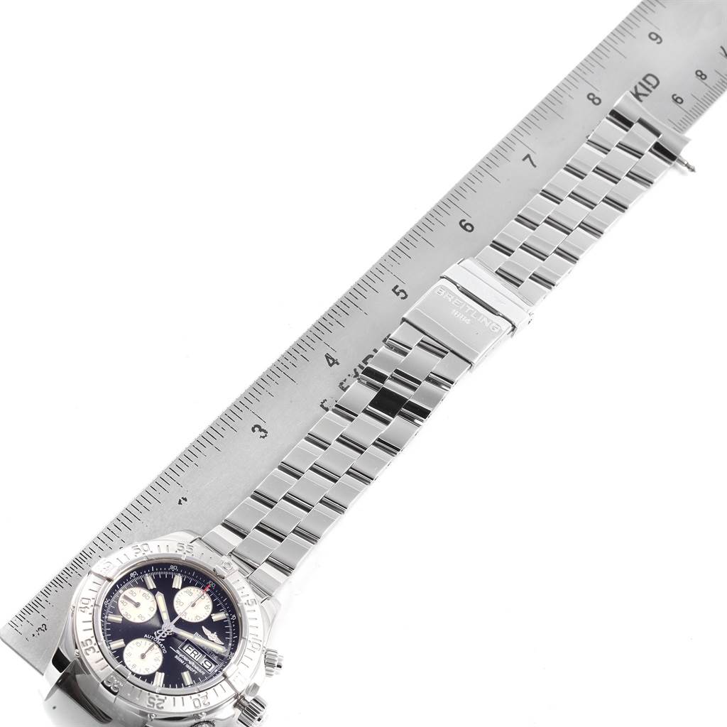 The image shows the Breitling Superocean A13340 Men's Stainless Steel Black Dial A13340 Men's Stainless Steel Black Dial watch laid flat, highlighting the watch face, metallic strap, and ruler for scale.