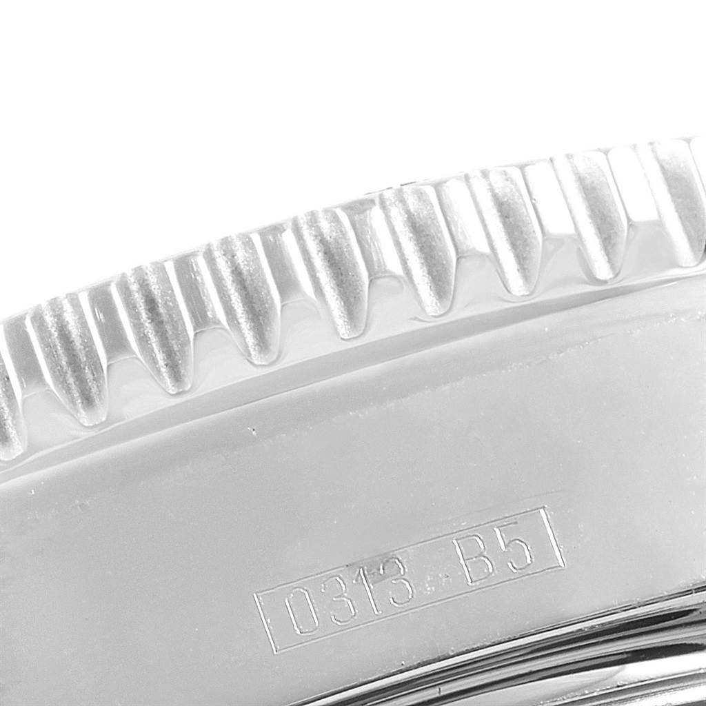 This is a close-up of the bezel on a Breitling Superocean A17391 Men's Stainless Steel Black Dial A17391 Men's Stainless Steel Black Dial watch, showing the serrated edge and part of the case with an engraved code.