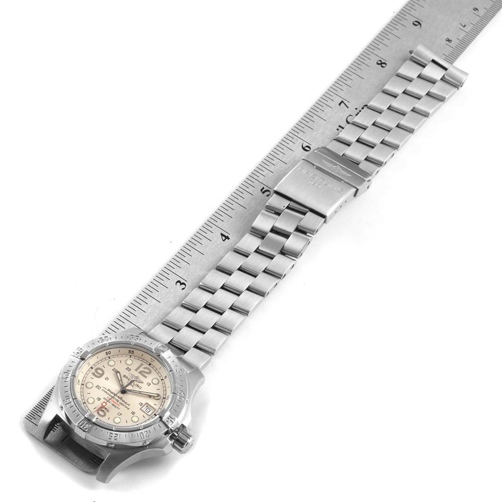 The image shows the dial, bezel, and metal bracelet of the Breitling Superocean A17390 Men's Stainless Steel Silver Dial A17390 Men's Stainless Steel Silver Dial watch at a slight angle accompanied by a ruler.
