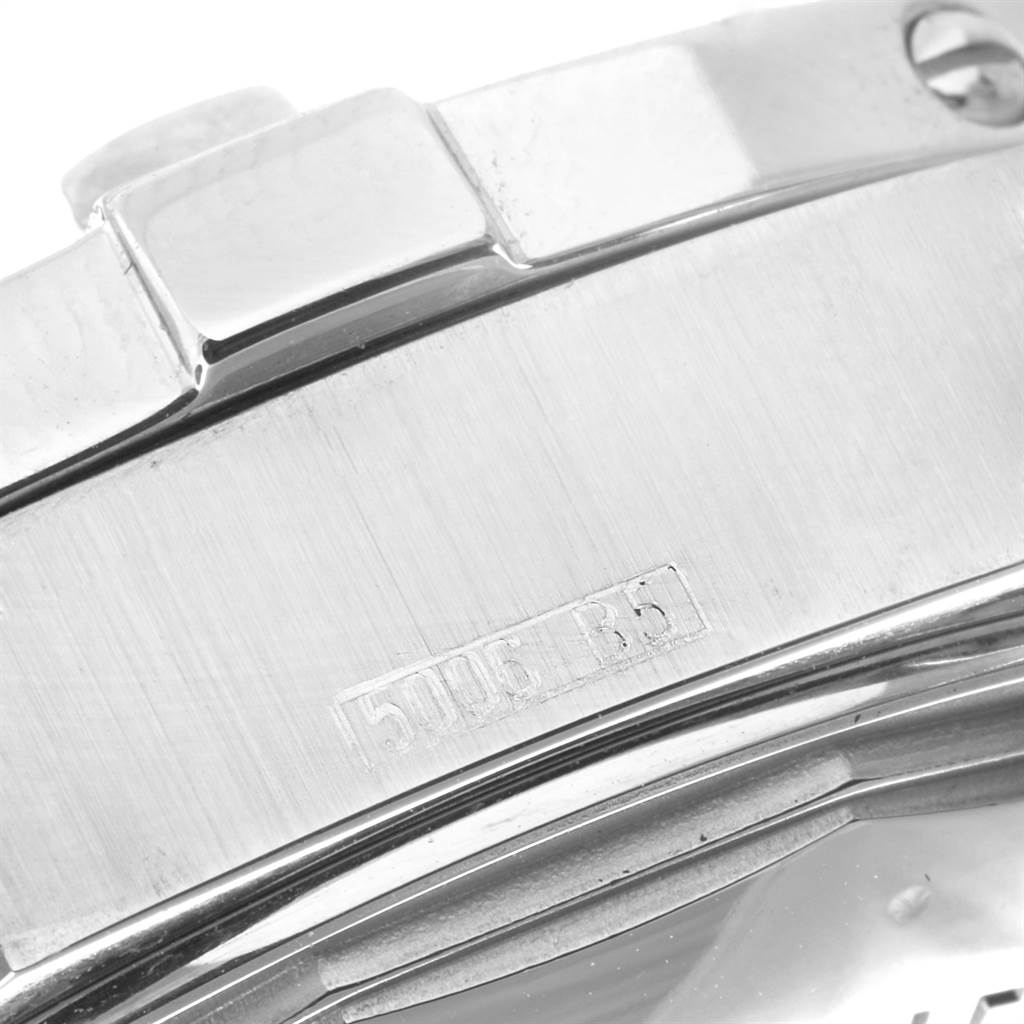 The image shows a close-up of the side of a Breitling Superocean A17390 Men's Stainless Steel Black Dial A17390 Men's Stainless Steel Black Dial watch, focusing on the metal casing and part of the engraved serial number.
