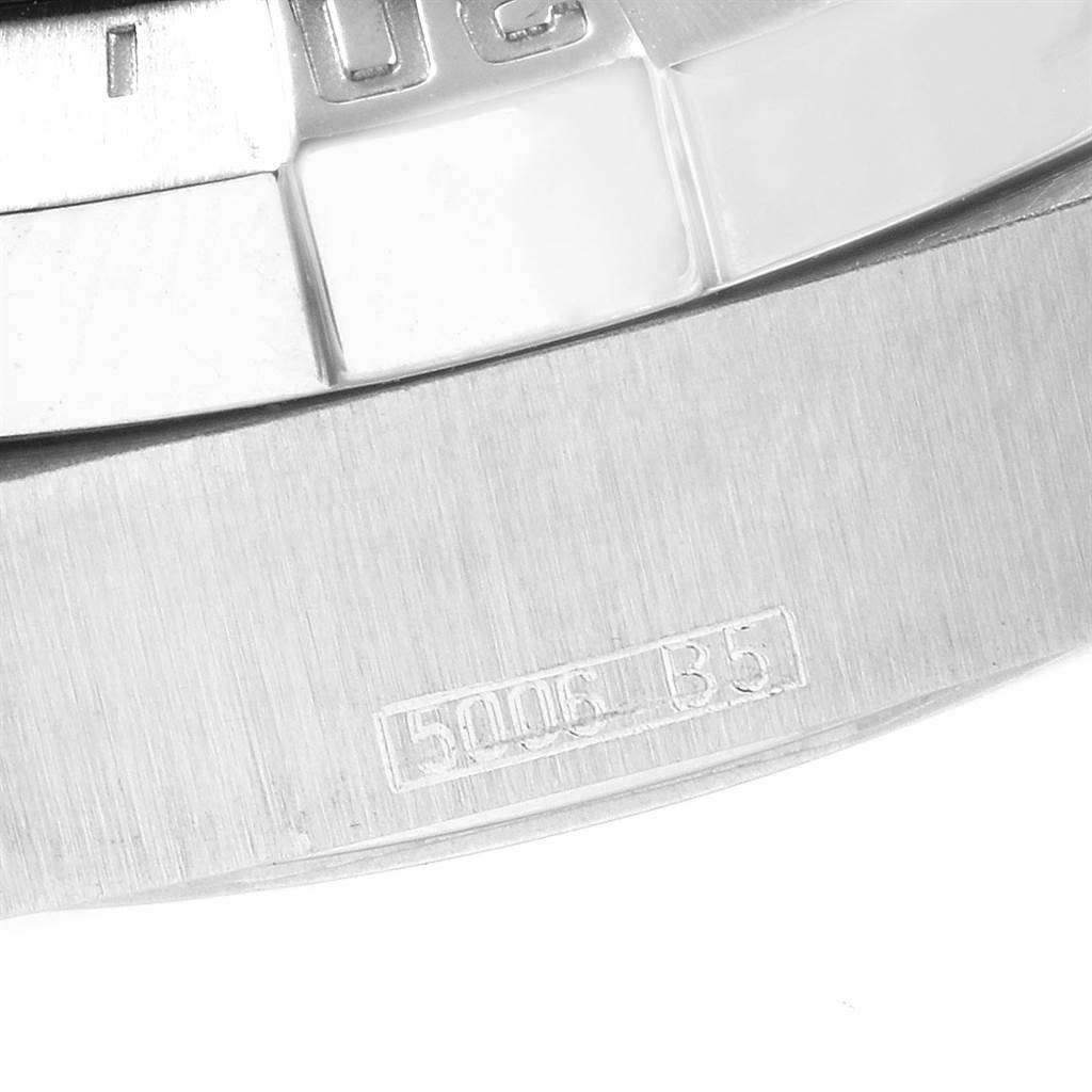 The image shows a close-up of the edge of a Breitling Superocean A17390 Men's Stainless Steel Blue Dial A17390 Men's Stainless Steel Blue Dial watch, including part of the bezel and engravings on the case.