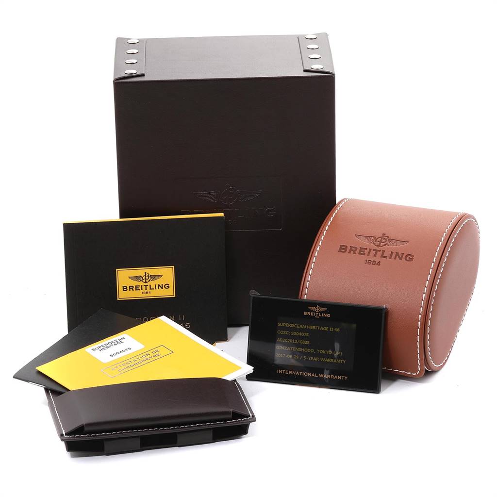 The image shows packaging and accessories for a Breitling Superocean AB2020 Men's Stainless Steel Silver Dial AB2020 Men's Stainless Steel Silver Dial watch, including a box, a leather case, and documentation.