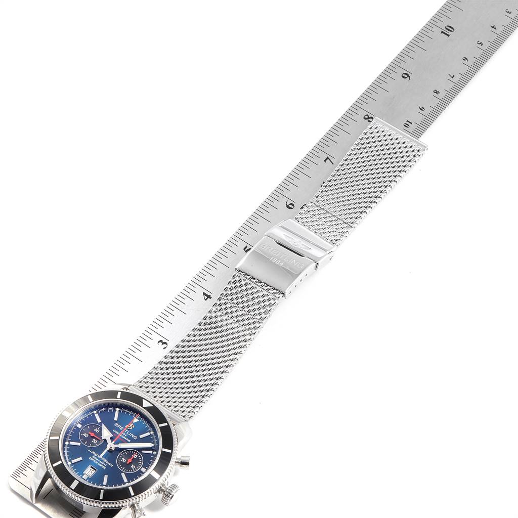 The watch, a Breitling Superocean A23320 Men
s Stainless Steel Blue Dial A23320 Men
s Stainless Steel Blue Dial model, is shown flat with a metal mesh strap beside a ruler for scale.