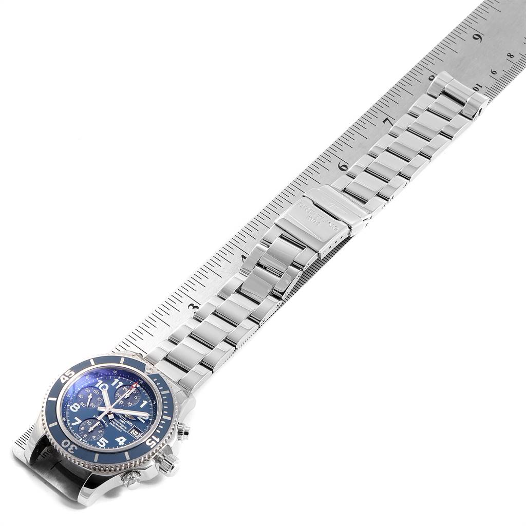 The image shows a Breitling Superocean A13311 Men's Stainless Steel Blue Dial A13311 Men's Stainless Steel Blue Dial watch lying flat with its stainless steel bracelet partially extended alongside a ruler.