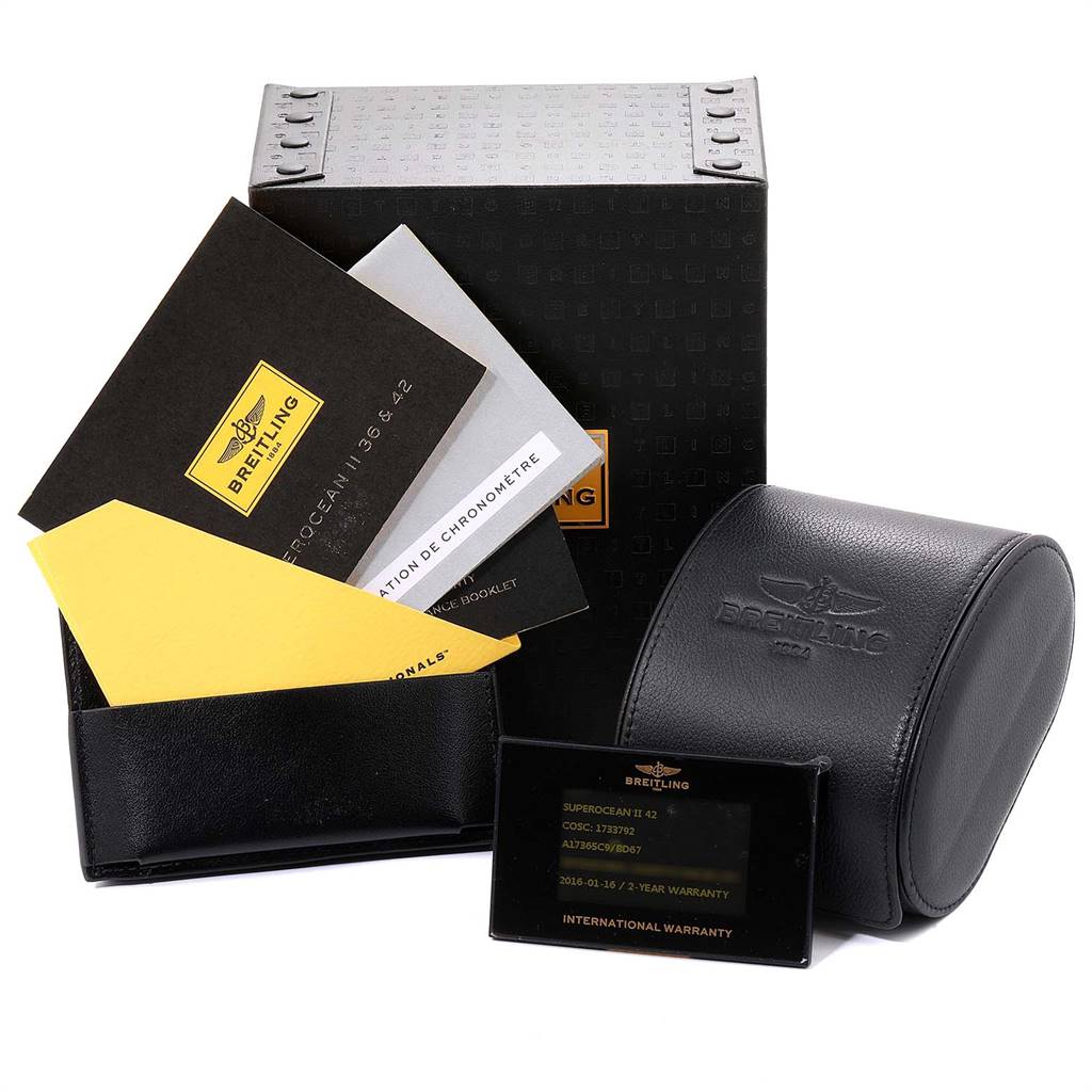 The image shows a Breitling Superocean A17391 Men
s Stainless Steel Black Dial A17391 Men
s Stainless Steel Black Dial watch box, international warranty card, booklets, and a leather watch case.