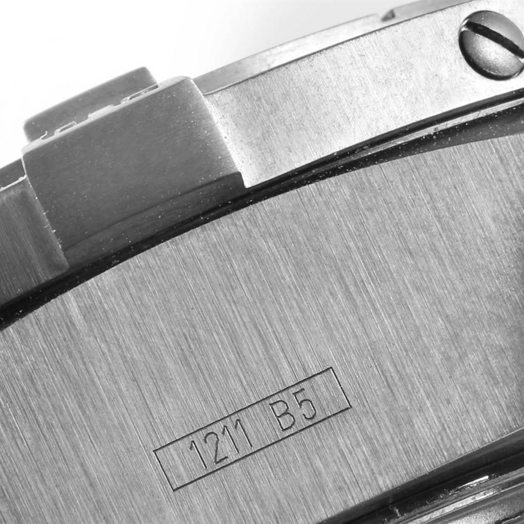 This image shows a close-up of the back casing of a Breitling Avenger M73390 Men
s Stainless Steel Black Dial M73390 Men
s Stainless Steel Black Dial watch, highlighting the strap attachment and engraved serial number.