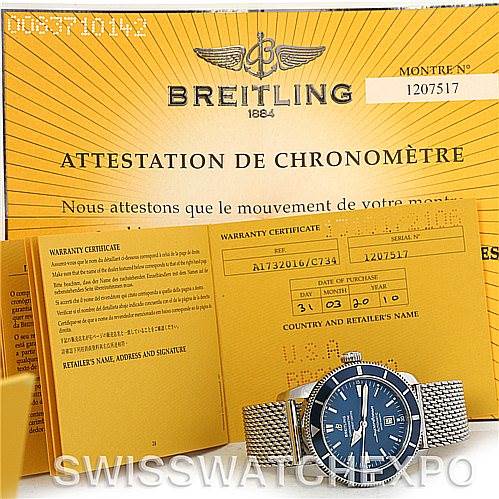 The image shows a Breitling Superocean A17320 Men's Stainless Steel Blue Dial A17320 Men's Stainless Steel Blue Dial watch placed in front of warranty certificates and the certificate of chronometer.