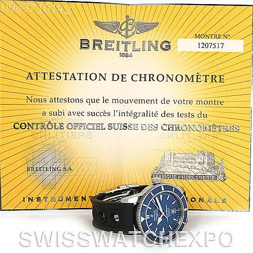 The image shows a Breitling Superocean A17320 Men's Stainless Steel Blue Dial A17320 Men's Stainless Steel Blue Dial watch photographed from a low angle, positioned in front of its chronometer certification.