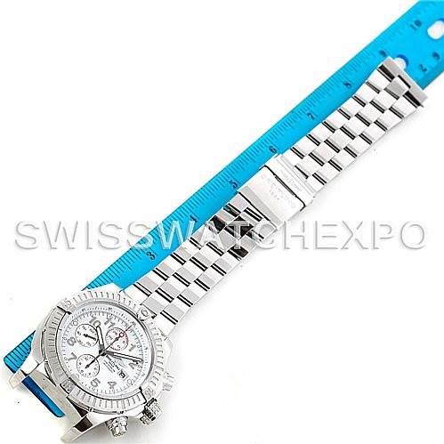 The Breitling Avenger A13370 Men's Stainless Steel White Dial A13370 Men's Stainless Steel White Dial watch is shown from a top-down angle, highlighting its face, bezel, and metal bracelet beside a blue ruler.