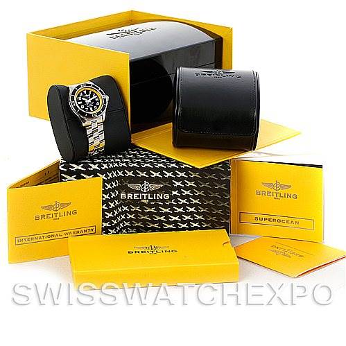 The image shows a Breitling Superocean A17364 Men's Stainless Steel Black Dial A17364 Men's Stainless Steel Black Dial watch and its packaging, including a black case, yellow manuals, and warranty cards.