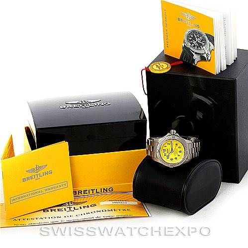 The Breitling Avenger E17370 Men's Titanium Yellow Dial E17370 Men's Titanium Yellow Dial watch is displayed at a side angle along with its black box, warranty card, and manuals.